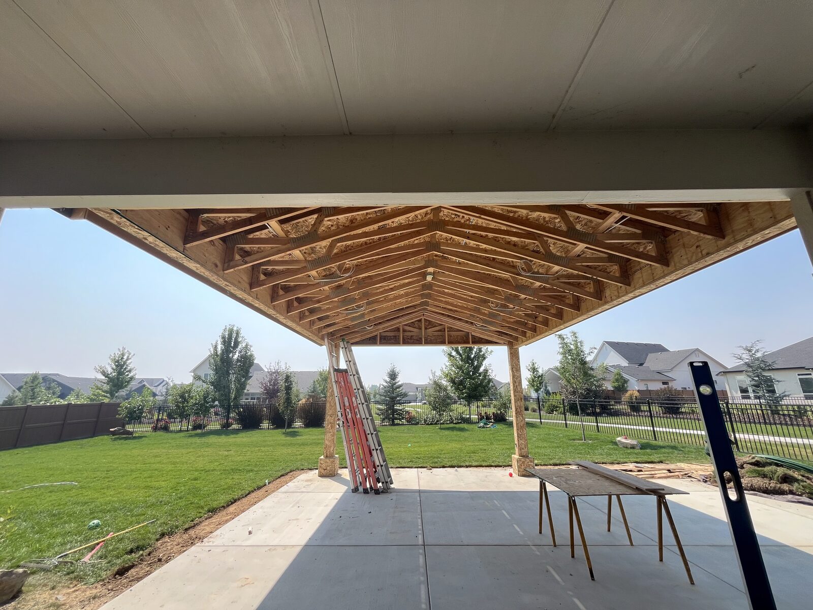 Underside of a gable patio cover showing custom roof framing