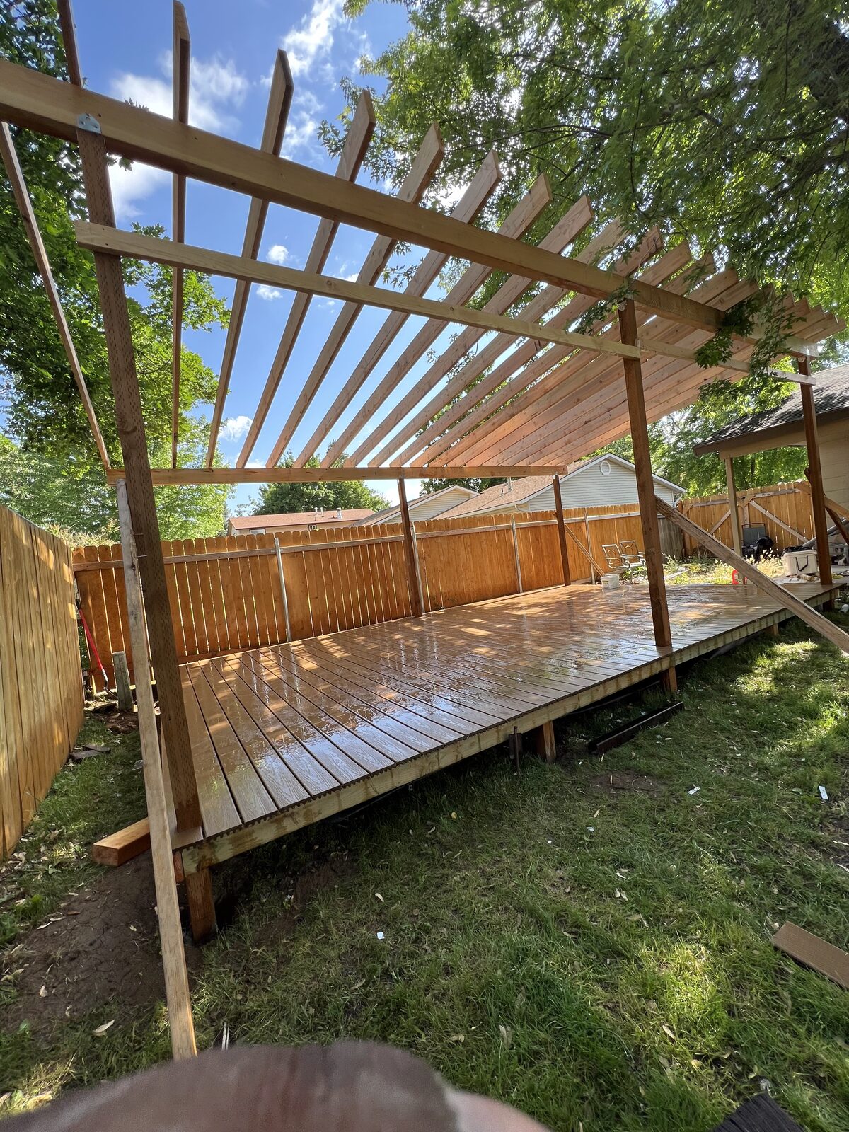 Open-slat cedar pergola over a wood deck