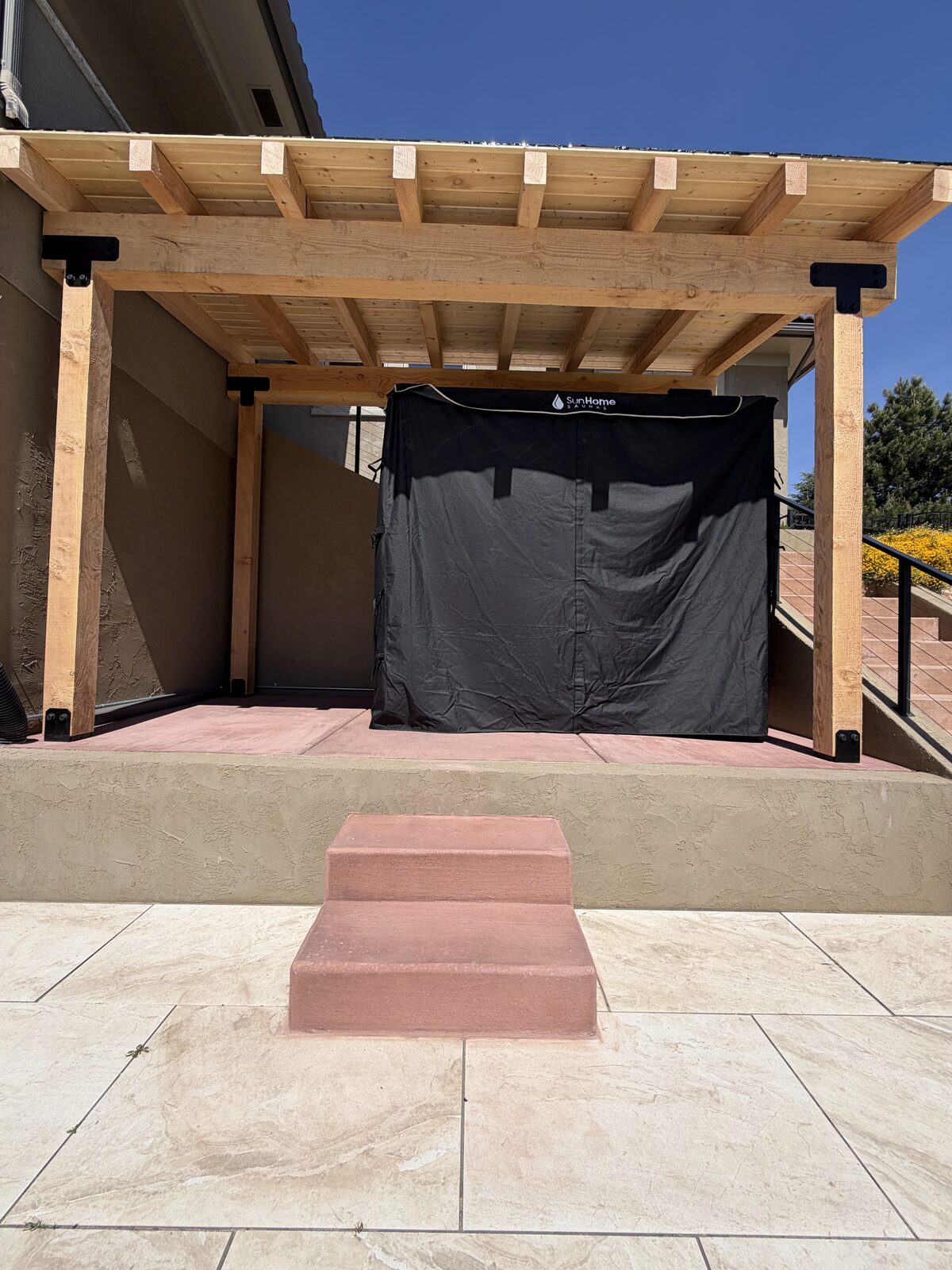Cedar pergola sheltering a backyard hot tub as part of an outdoor living space